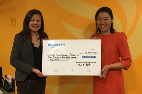 Merlene Emerson presents Sarah Cheung Johnson with a Chinese LibDems grant